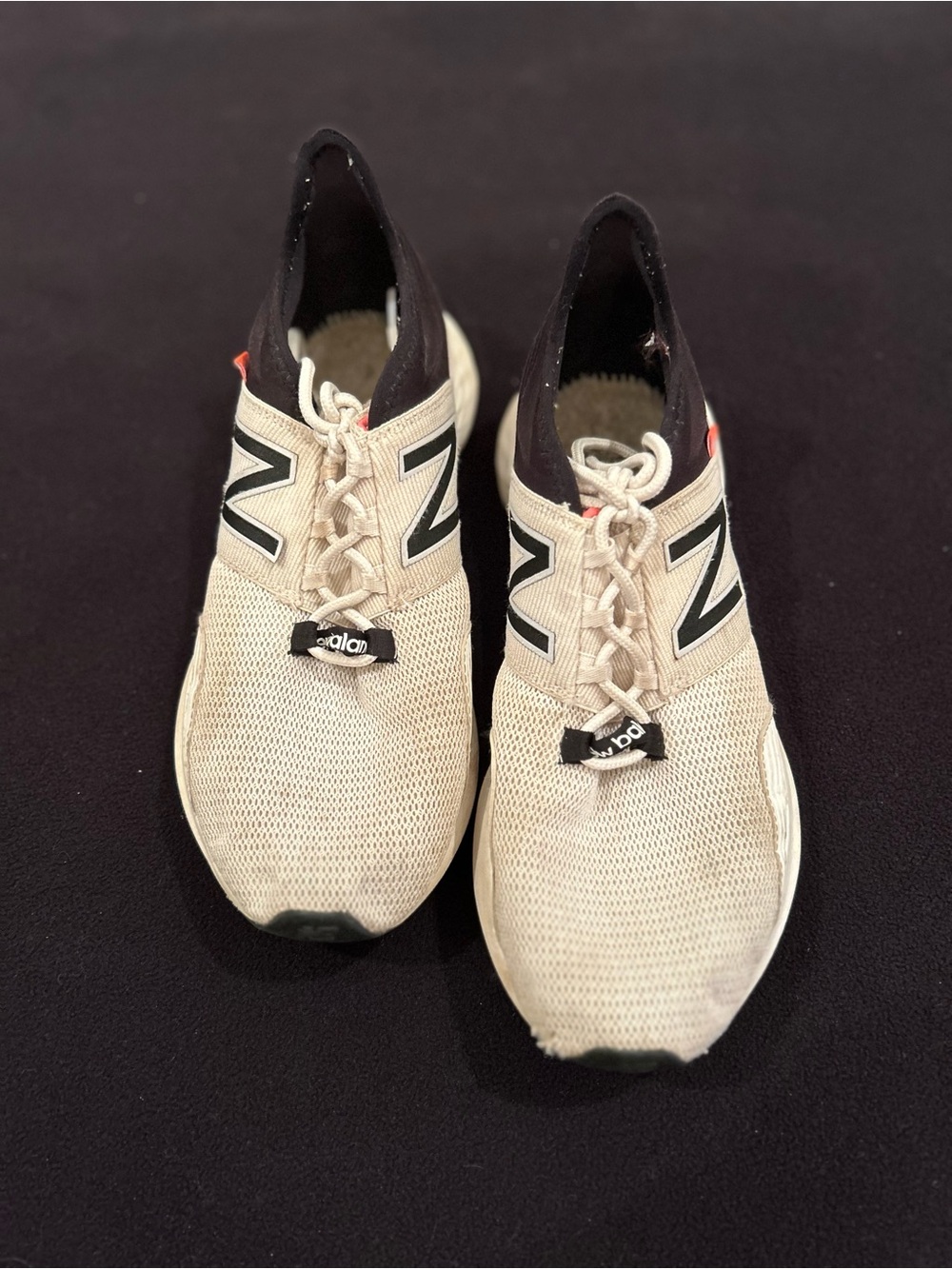 New Balance women’s Beige and Black Knit Slip-On Athletic Sneakers